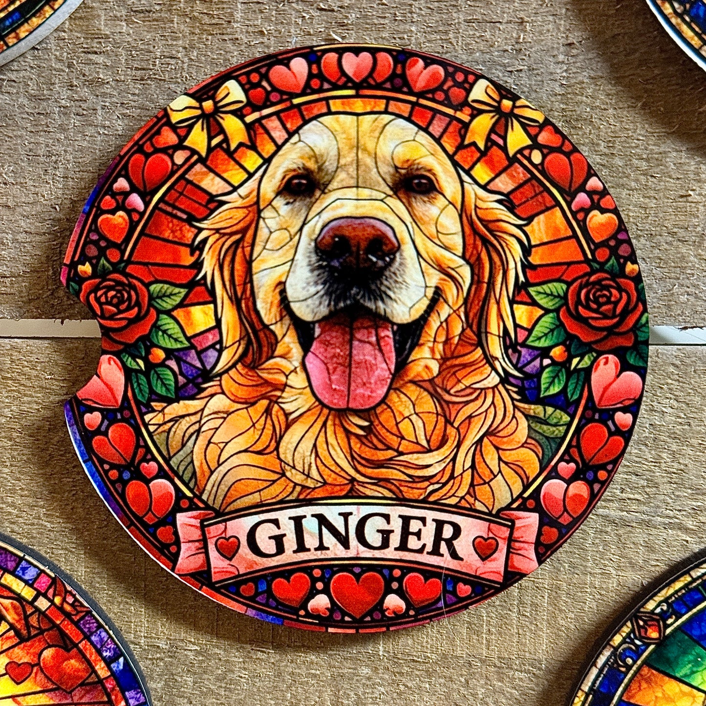 Decorative plate with a golden retriever named 'Ginger' surrounded by hearts and flowers on a wooden surface.
