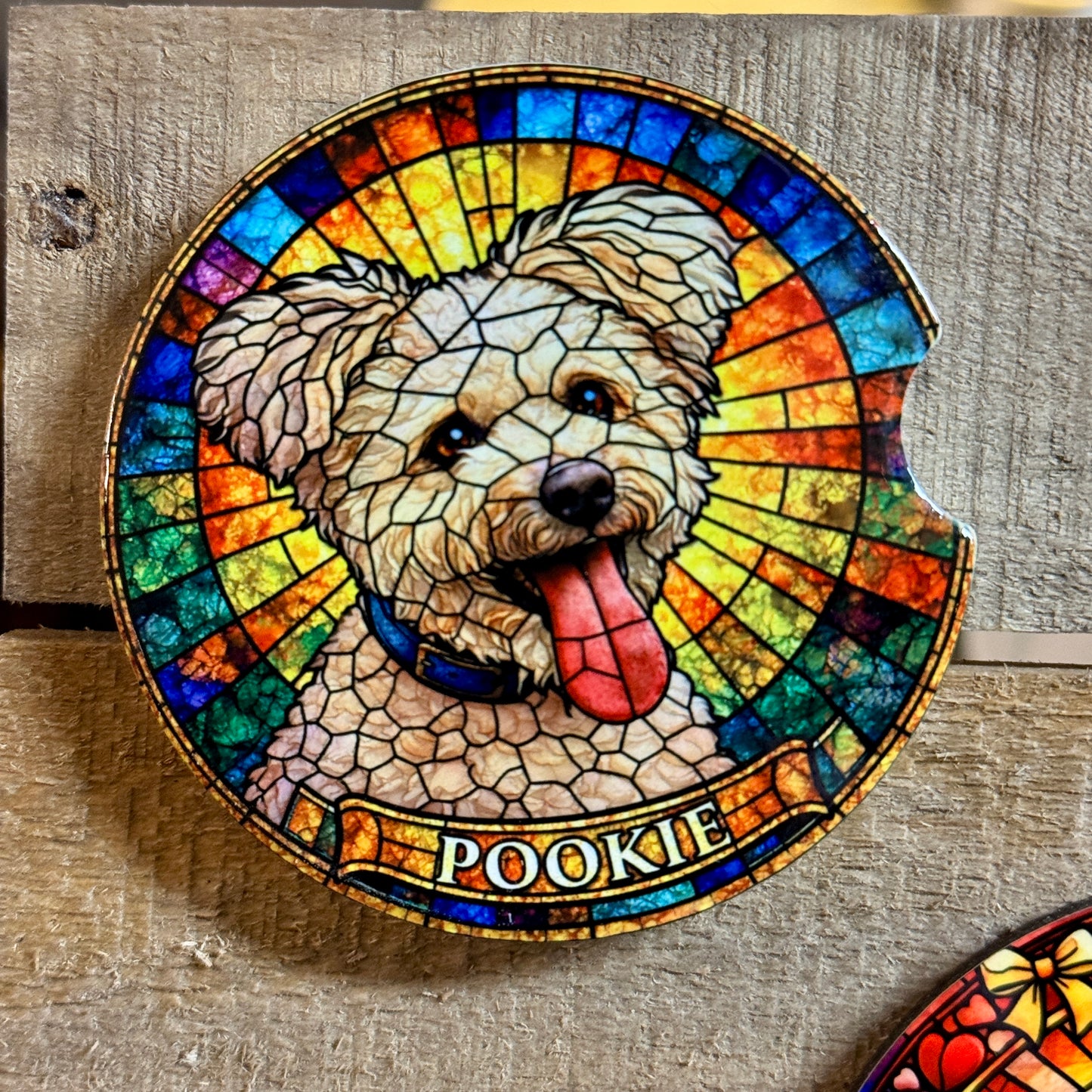 Stained glass-style pet portrait of a dog named 'Pookie' on a wooden surface.