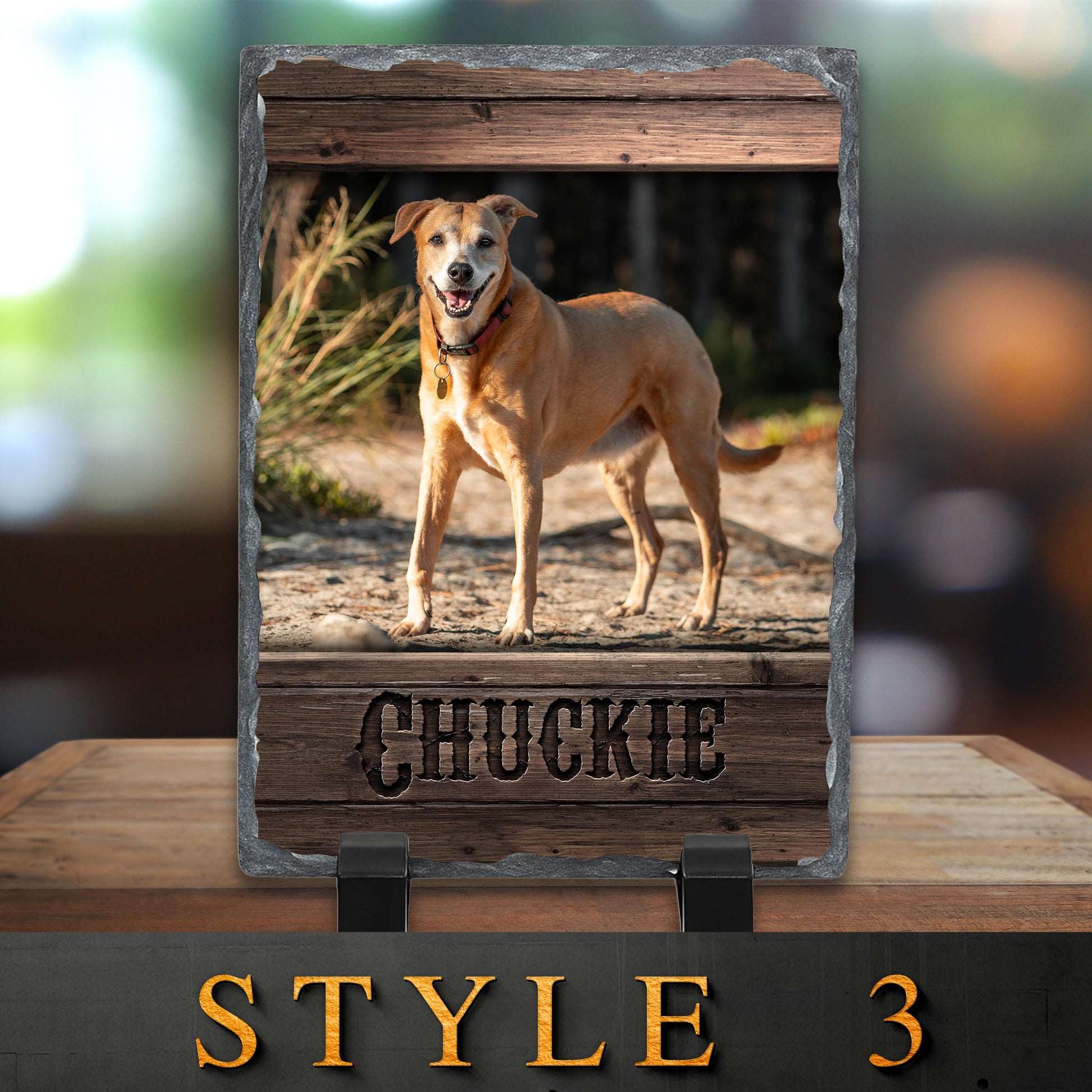 Dog standing on a wooden platform with 'Chuckie' engraved, framed by a wooden border.