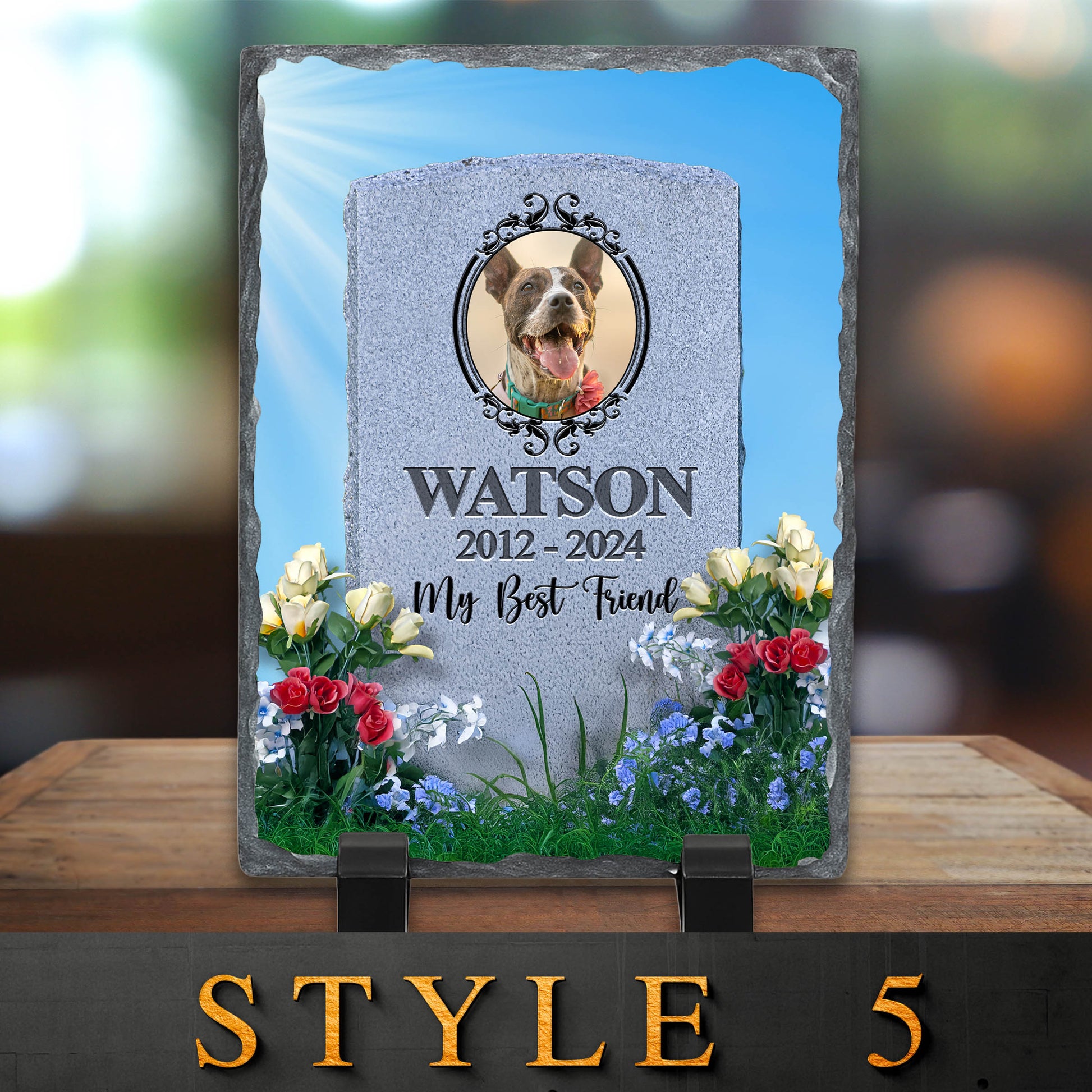 Memorial stone for a dog named Watson with flowers and a blurred background