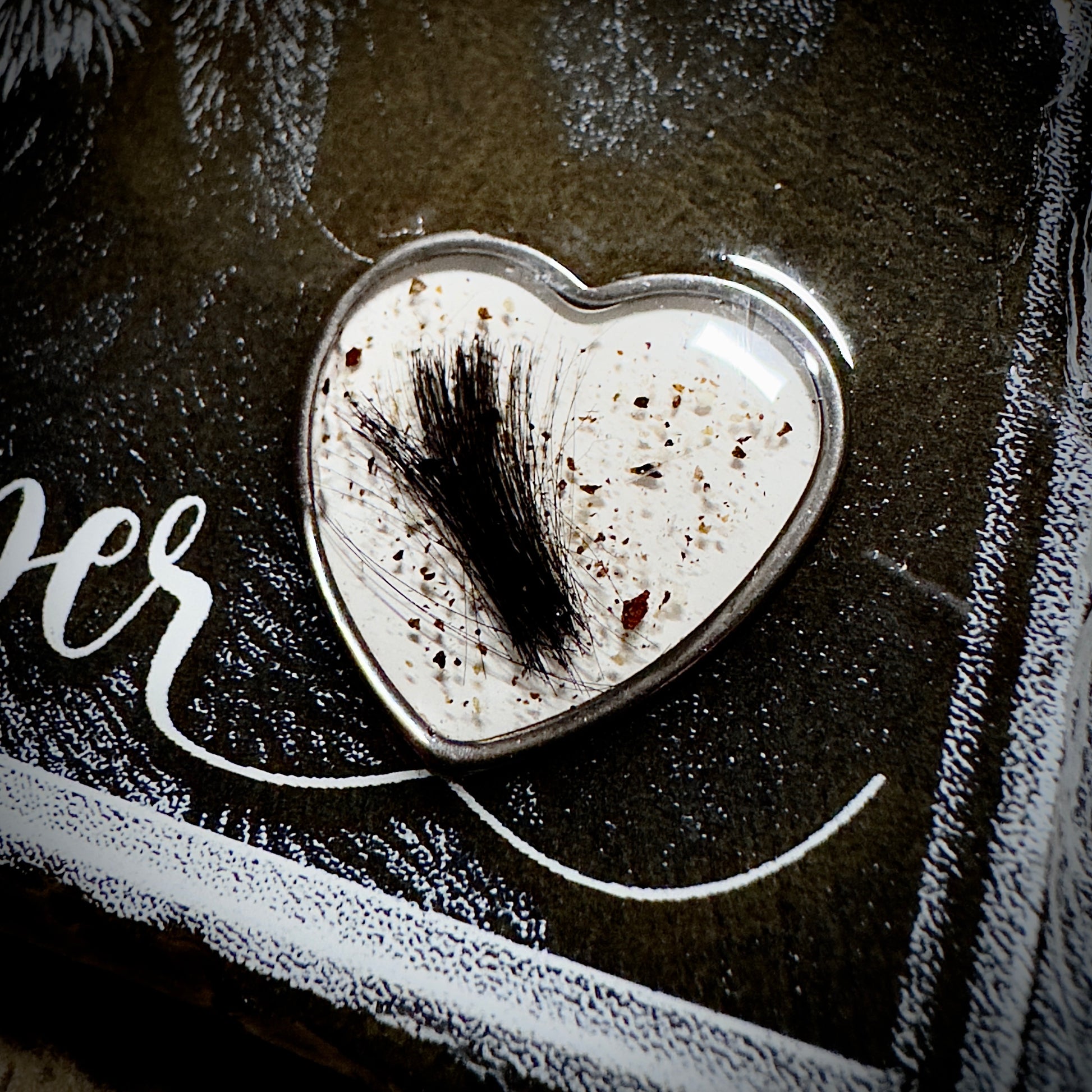Heart-shaped ring with preserved fur and cremains