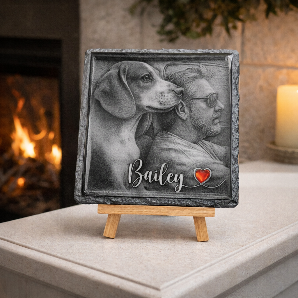 Personalized pet portrait on a slate plaque with a wooden stand, set against a warm fireplace background.