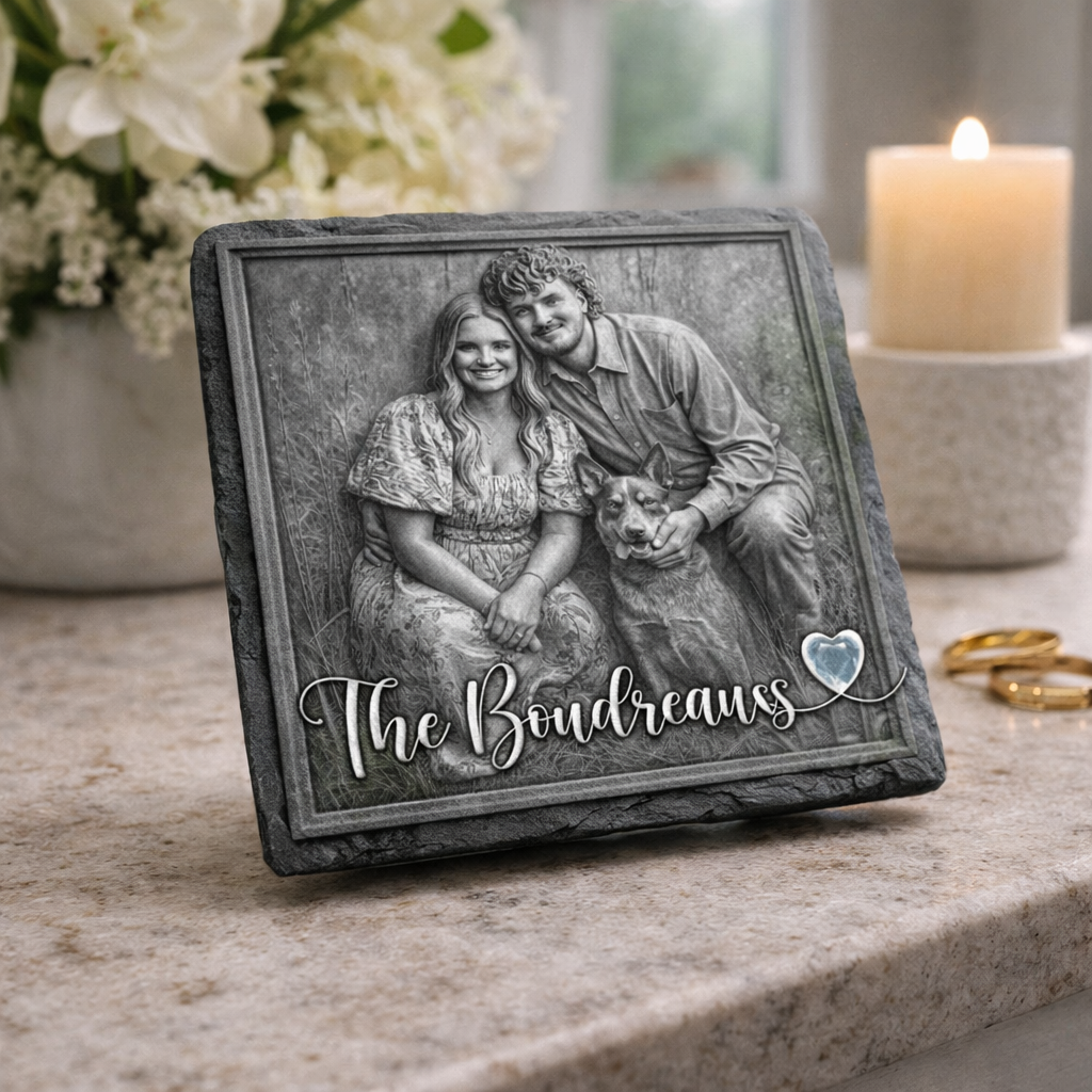 Personalized photo plaque of a couple with their dog, featuring the name 'The Boudreauxs', on a table with flowers and a candle in the background.