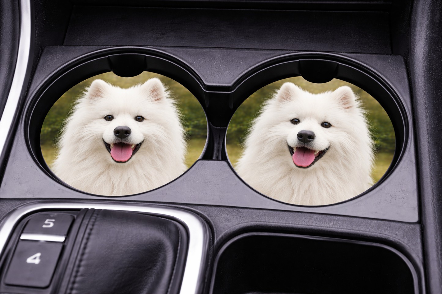 Car cup holder with two circular coasters featuring a white dog, placed inside a vehicle.