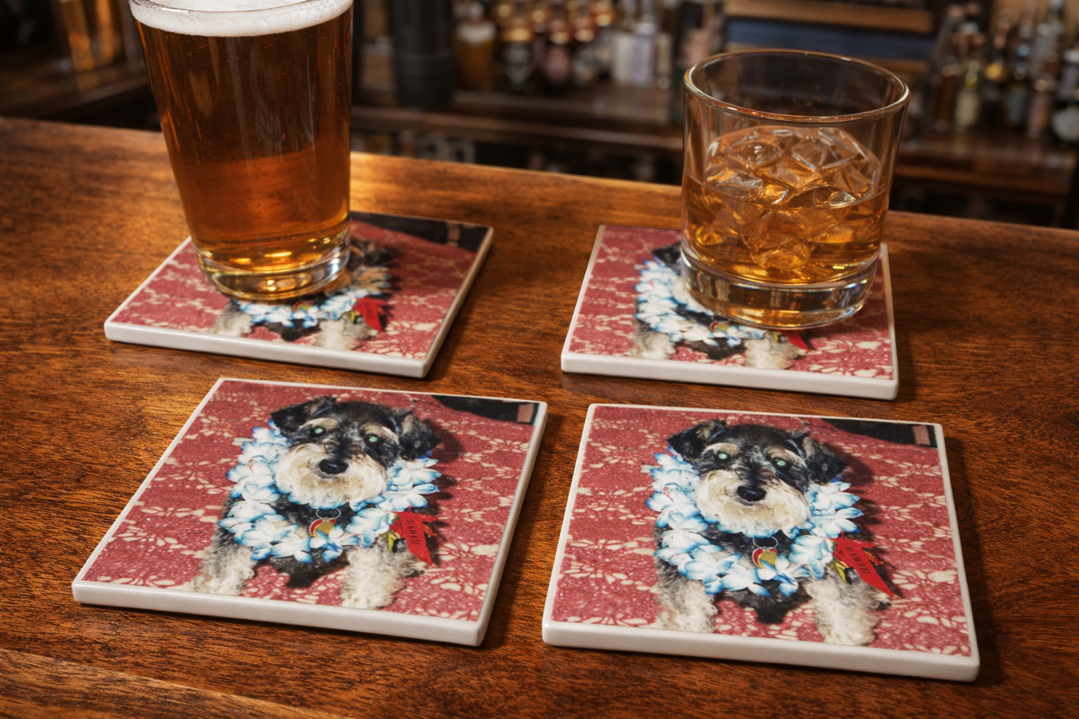 Set of four coasters with dog illustrations on a wooden surface with glasses of beer.