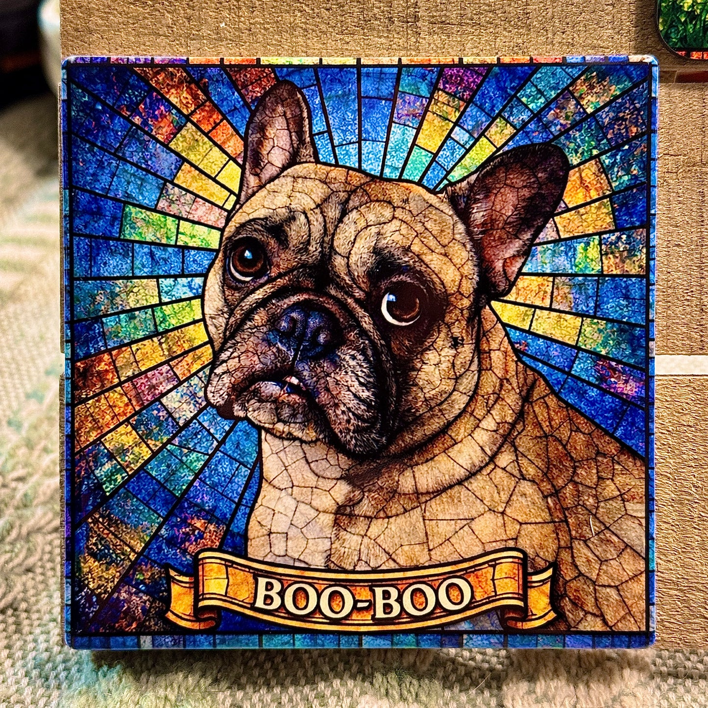 Stylized dog portrait with 'BOO-BOO' banner against a colorful, mosaic-style background.