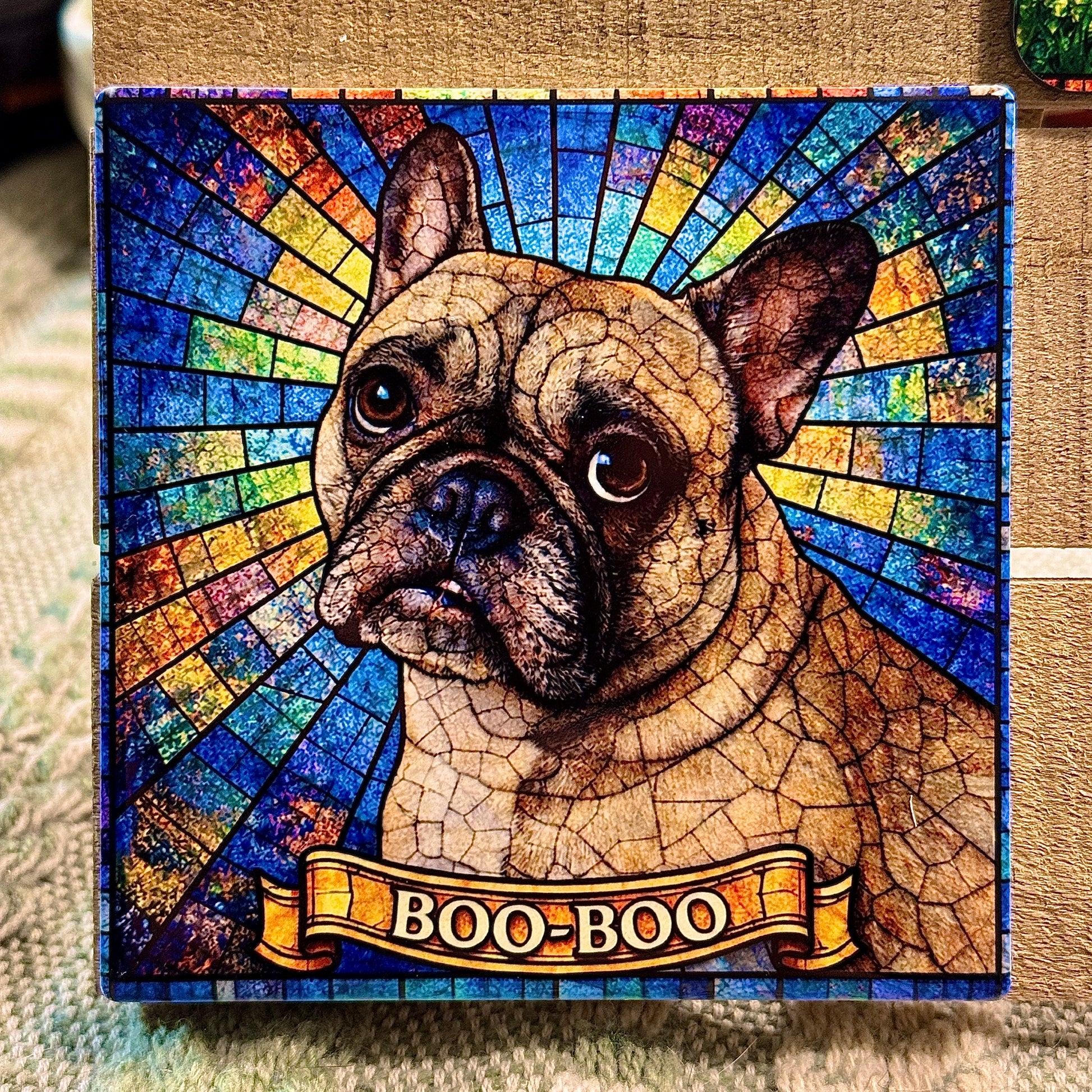 Stylized dog portrait with 'BOO-BOO' banner against a colorful, mosaic-style background.